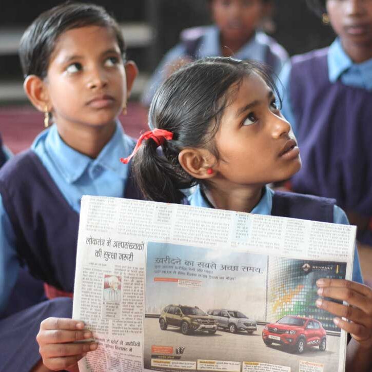 student holding a newspaper