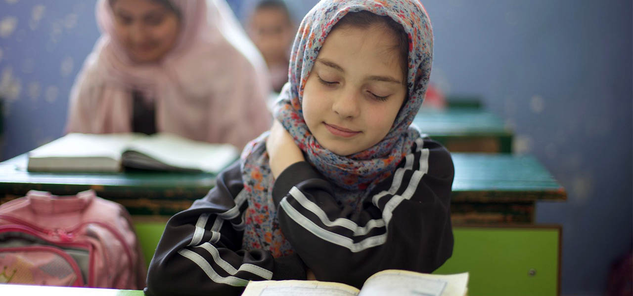 Group of young students in Jordan focusing on their studies in a classroom