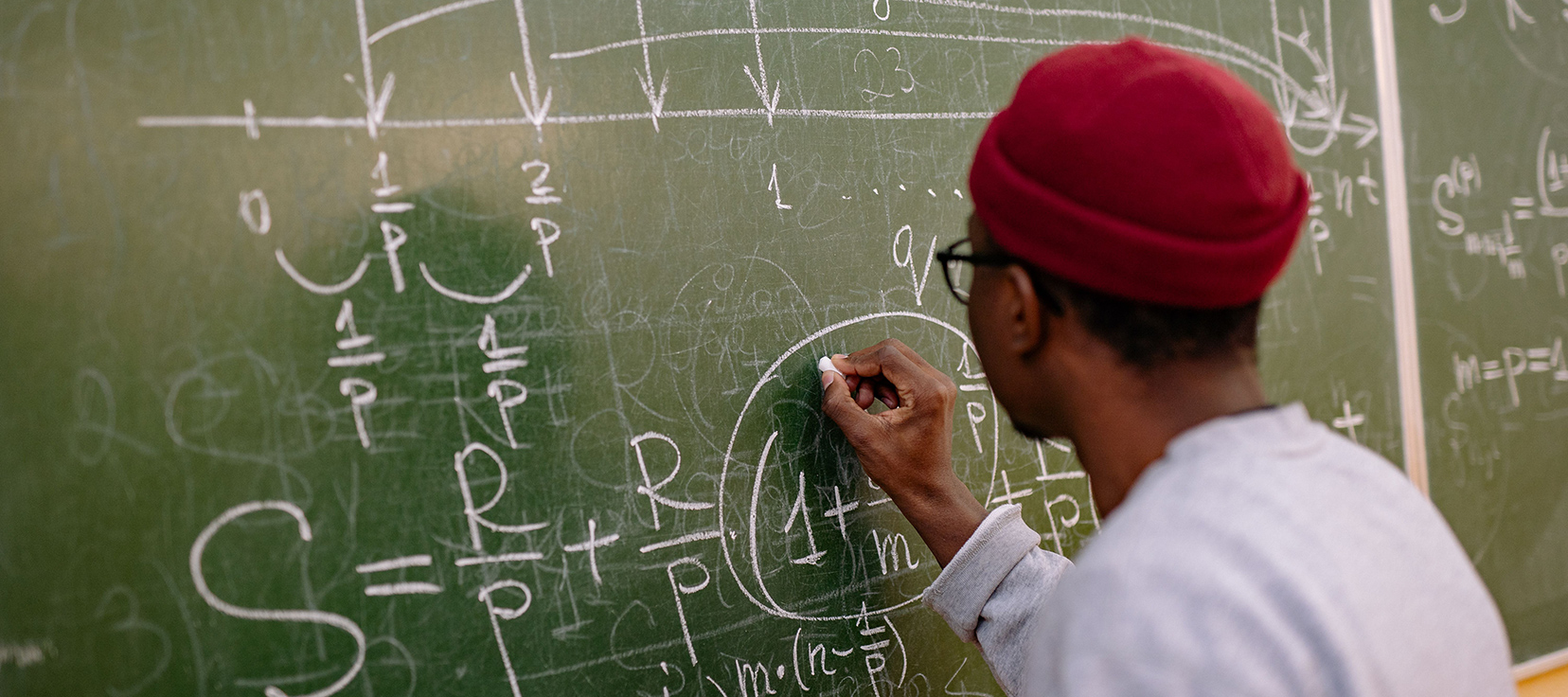 teacher writing on a whiteboard